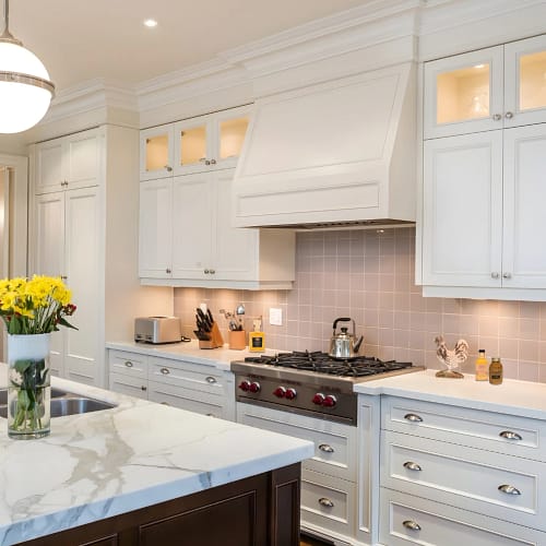 Bright, calm kitchen with white cabinets and clean countertops representing a Christmas to New Year reset in the home kitchen