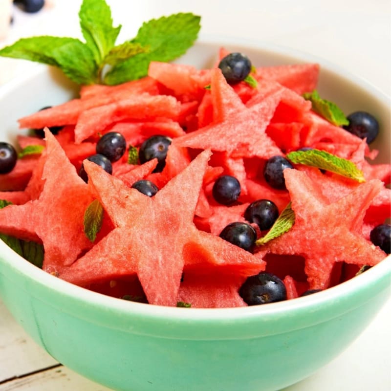 Watermelon Salad with star-shaped watermelon pieces, blueberries, and fresh mint for the June 30 Summer Bites class.