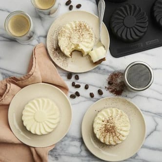 Flower Power tiramisu molded in bon COOK FORTEEZ Flower Mold, with cocoa-dusted tops and a sliced center showing creamy layers.