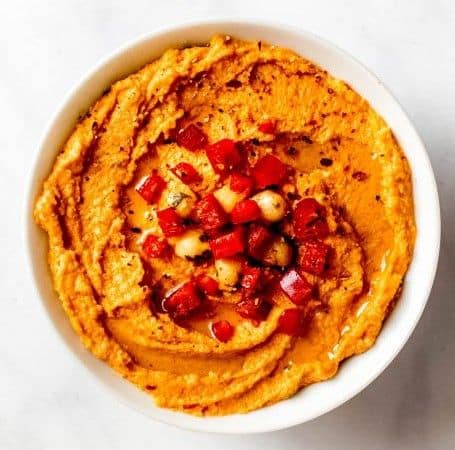Roasted red pepper hummus topped with diced vegetables for gluten free Thanksgiving recipes