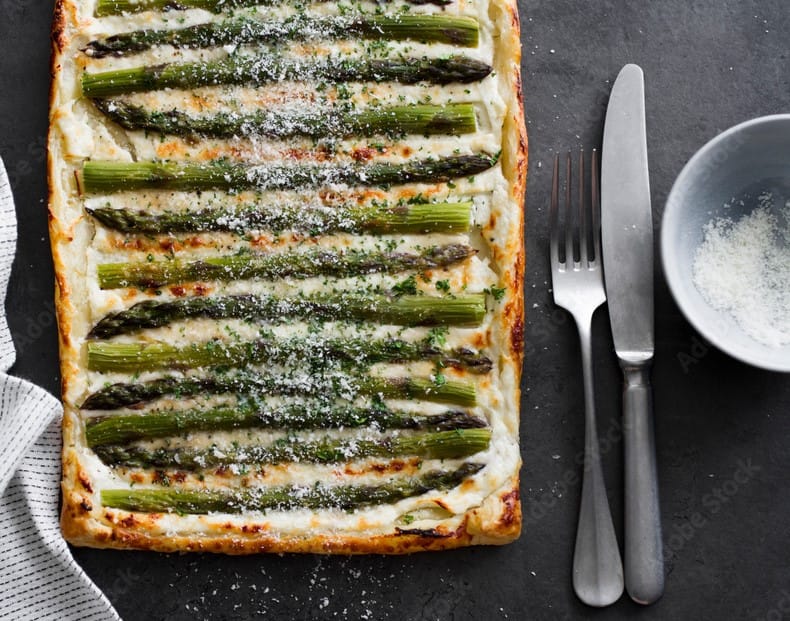 Asparagus tart topped with cheese and herbs to enhance flavor with dried and fresh ingredients