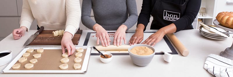 People cooking together using bon COOK bakeware and essential tools.